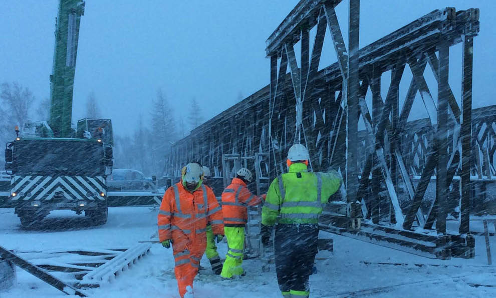 Temporary bridge being built during stormy weather